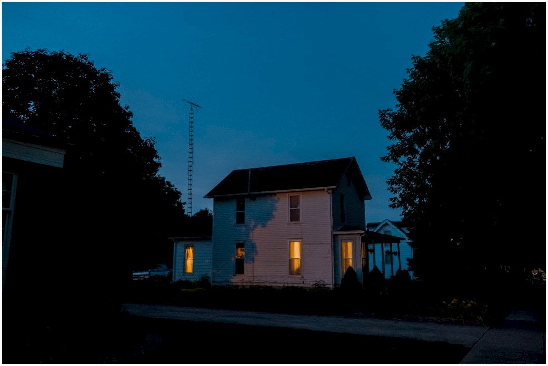 a house is lit up at night with the lights on
